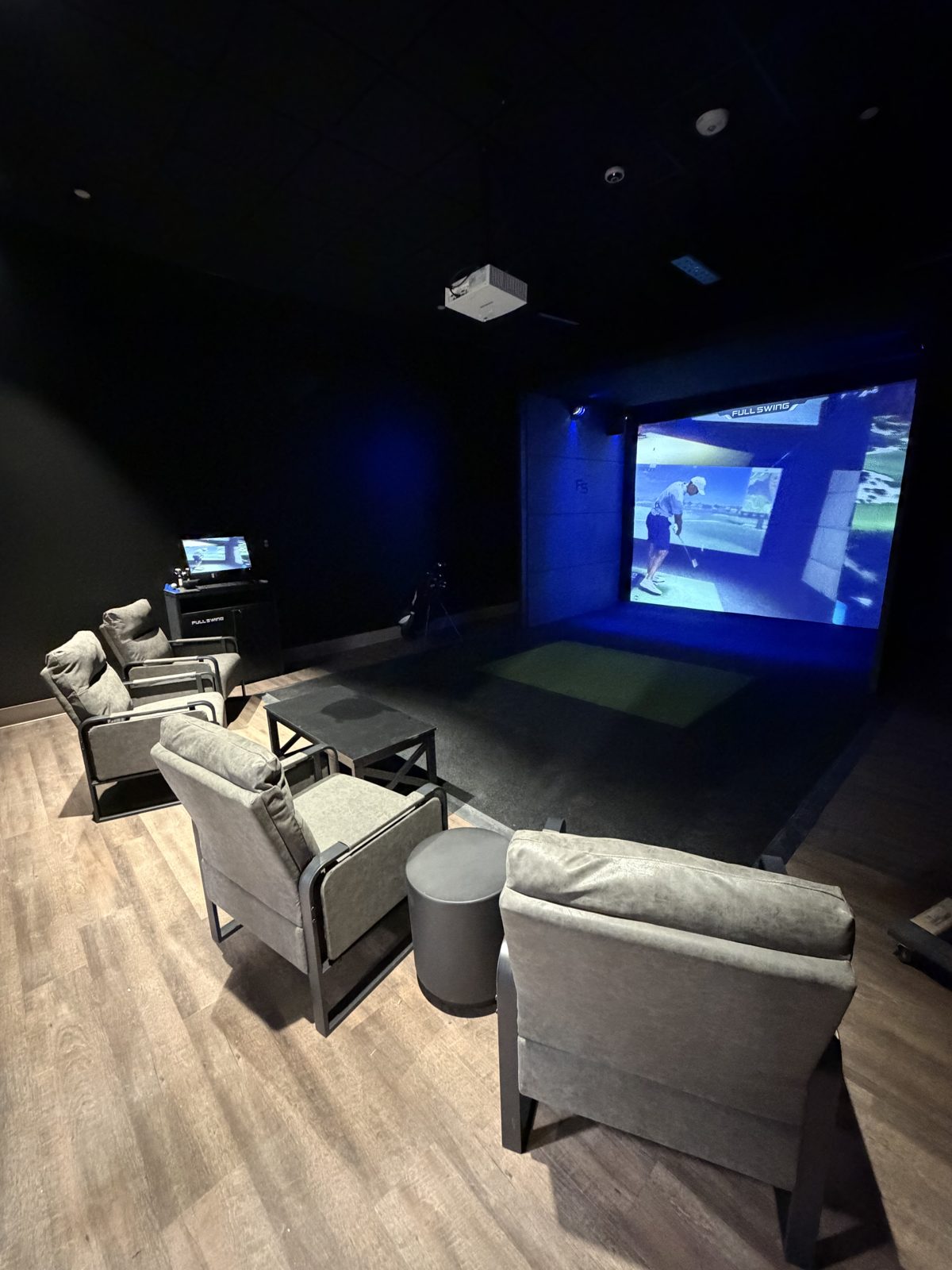 Lounge seating in the sports simulator room at Alleyway Entertainment